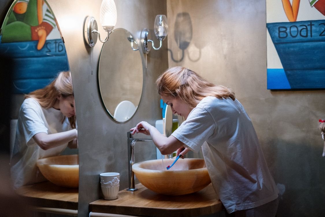 Woman brushing her teeth in a bathroom